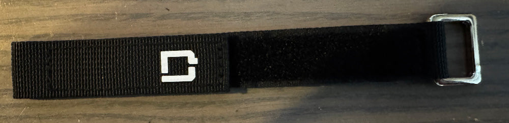 Close up shot of the DamagD LiPo battery strap with white DamagD "D" logo for FPV drones.