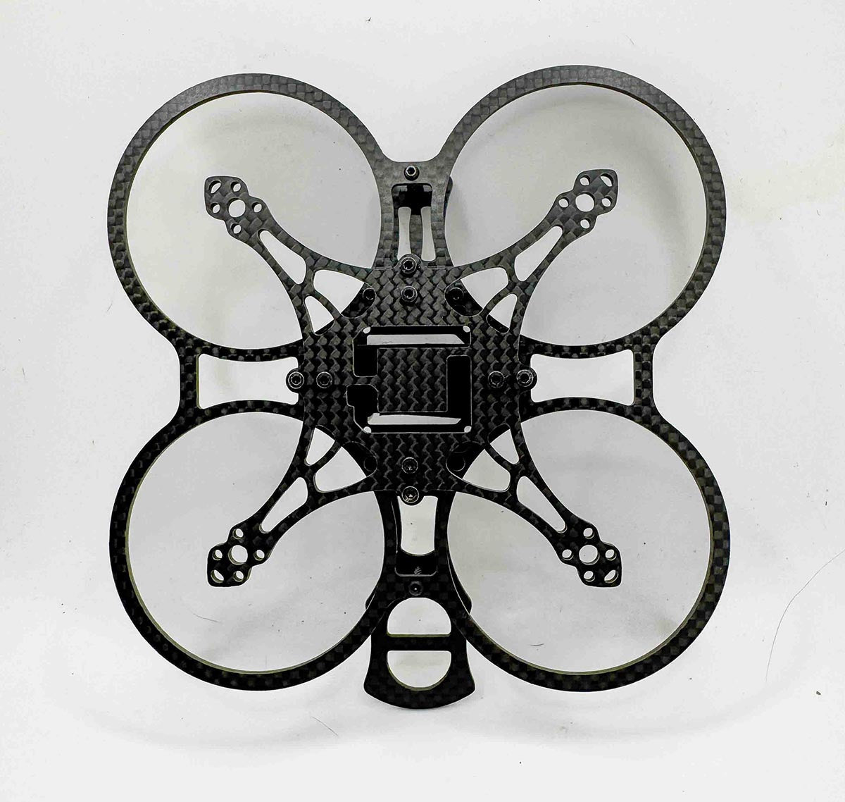 Bottom view of Osito carbon FPV frame showing symmetrical motor layout and lightweight construction; a design philosophy shared with competitors like the AOS cine line and the Itsy Spydr