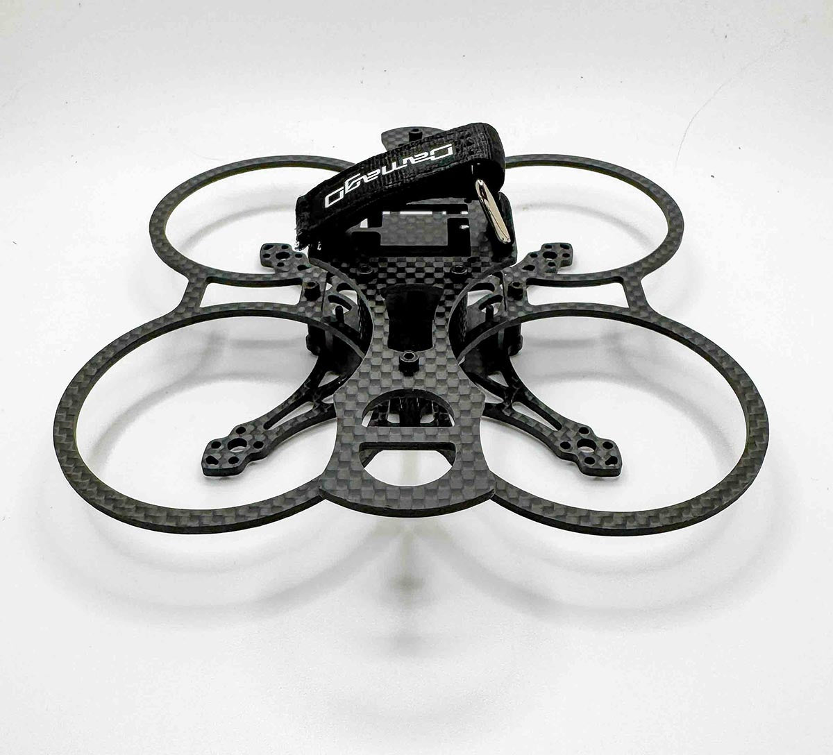 Front-facing view of the Osito FPV drone frame, showcasing lightweight carbon design and duct-style prop guards; built as a freestyle-capable cinewhoop rivaling the Itsy Spydr, AOS, and BetaFPV Pavo 20 Pro
