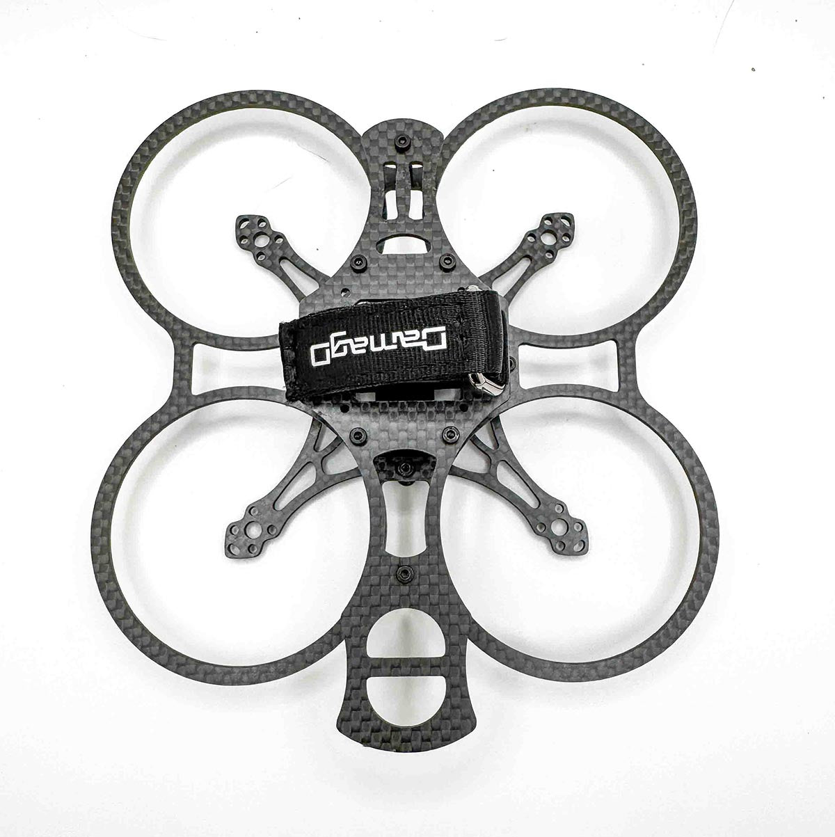 Top-down shot of the built Osito drone, featuring HQProp T2.2x1.6x3 props and DamagD branding; designed as a cinematic-meets-freestyle alternative to frames like the AOS Cinewhoop and Pavo 20 Pro