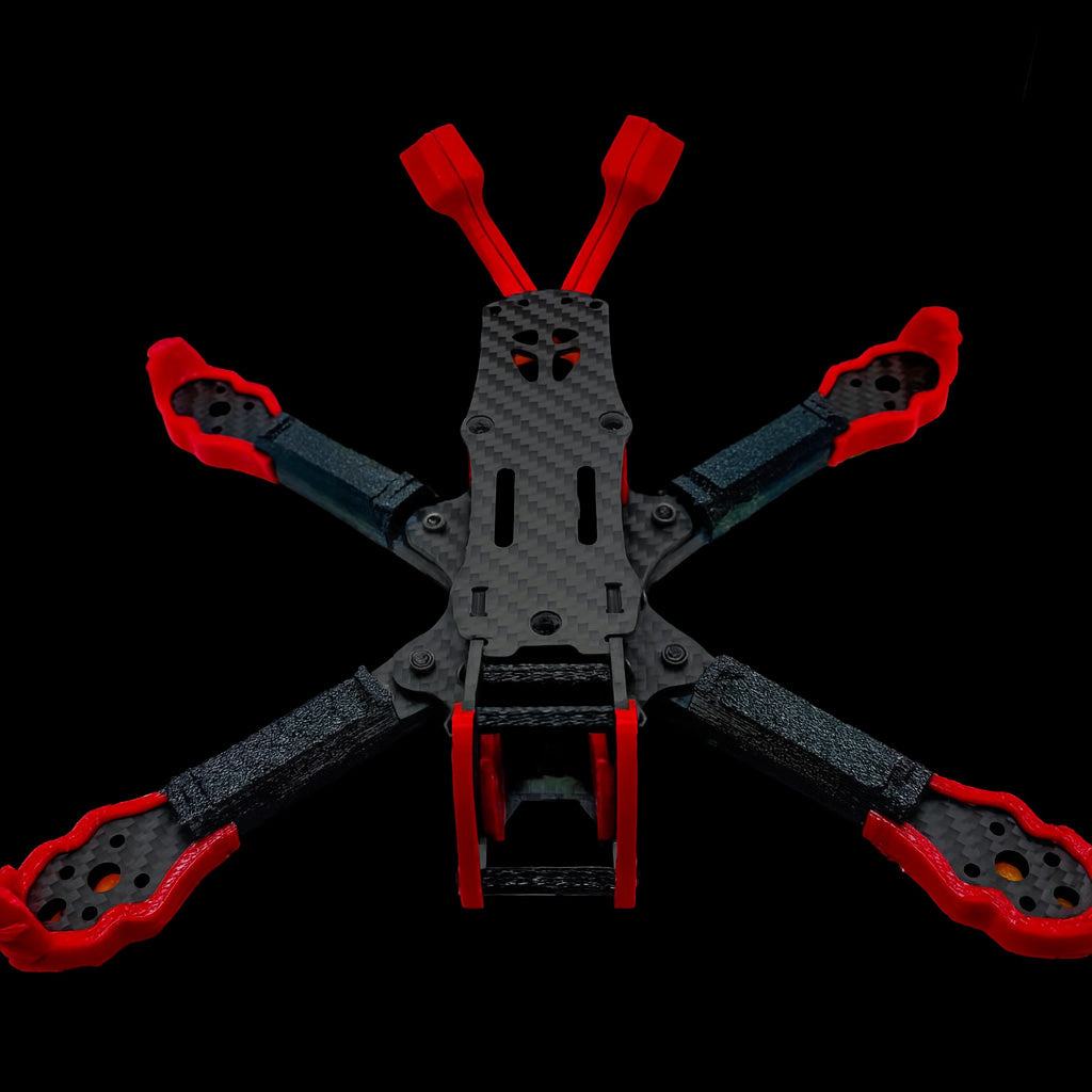 Shredpool 3D printed accessory kit in red and black TPU mounted on the ILLmatic FPV frame; rugged protection for freestyle rigs like TANQ, Vannystyle, Syncmode, Flipmode, Apex, and ERA.