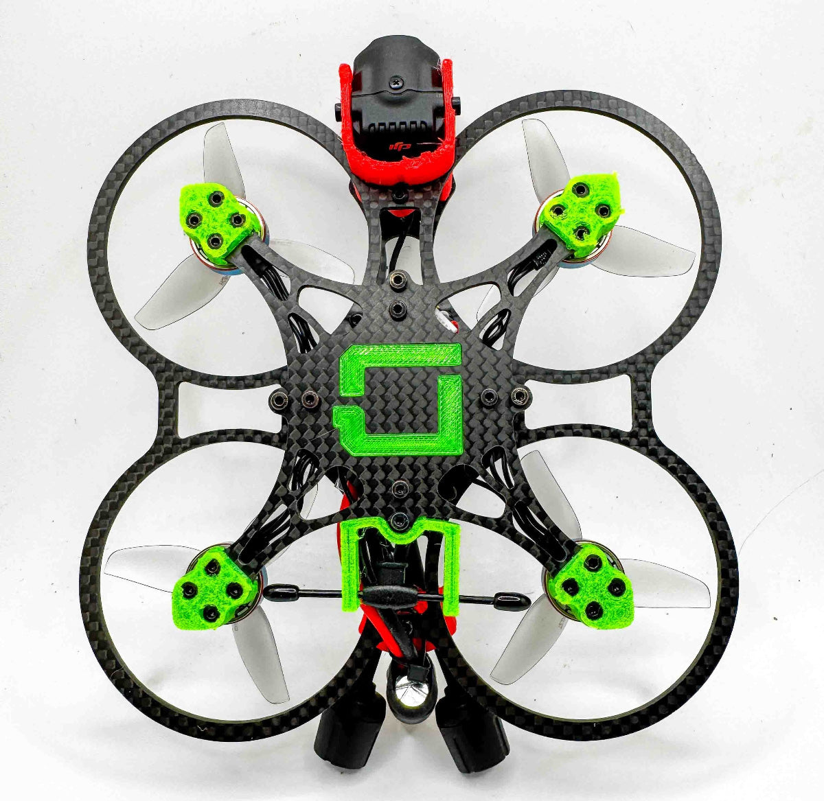 Bottom view of the fully built Osito FPV drone with Vandal 1303 motors and TPU components; a compact hybrid rig comparable to the RCINPOWER-powered Itsy Spydr and cinematic frames like the Pavo 20 Pro