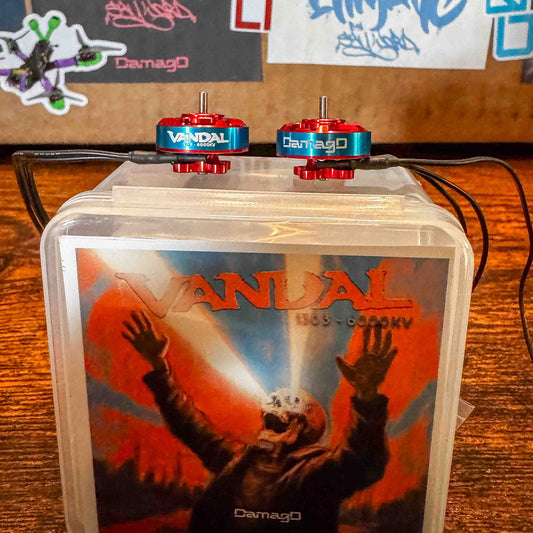 DamagD Vandal 1303 6000KV motors displayed on custom artwork packaging, designed for cinematic and freestyle FPV; a top-tier alternative to RCINPOWER and Caddx 1303 class motors.